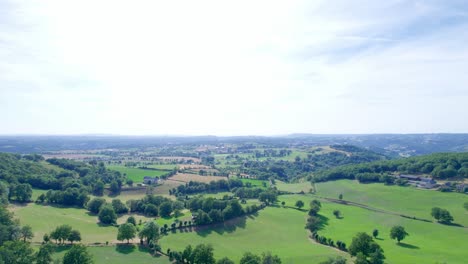 Panoramic-countryside-with-farms-and-fields,-aerial-view
