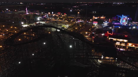 Flying-around-the-Kemah-Boardwalk-amusement-park,-night-in-Texas,-USA---Aerial-view