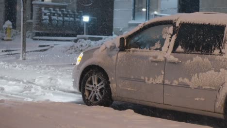 A-front-wheel-drive-van-struggling-to-move-and-spinning-its-tires-to-try-and-get-traction-with-the-road-after-a-massive-blizzard-brought-lots-of-snow-to-the-city