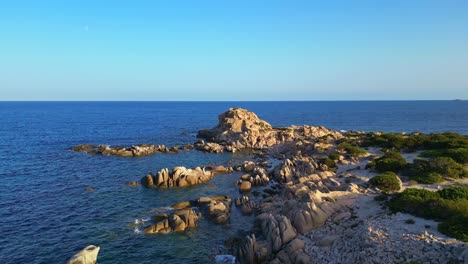 Coastline-of-rock-formations,-clear-ocean-water-and-blue-sky