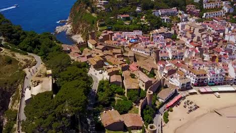 Flying-upwards,-above-a-historic-medieval-city-on-the-coastline-of-the-Mediterranean-Sea