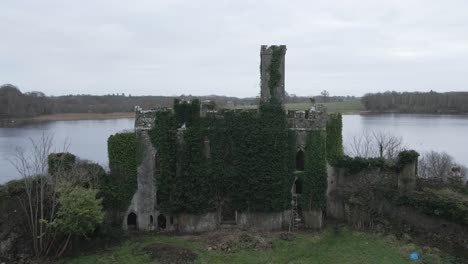 McDermott-Castle-ruins-on-an-island-in-Lough-Key,-Roscommon,-serene-lake-surroundings-drone-footage