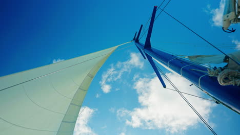 Wind-sailboat-main-mast-navigating-in-open-sea