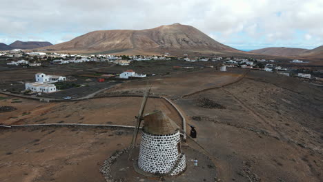 Aerial-drone-video-of-a-traditional-windmill-in-La-Oliva-village,-Fuerteventura,-Canary-Island,-Spain