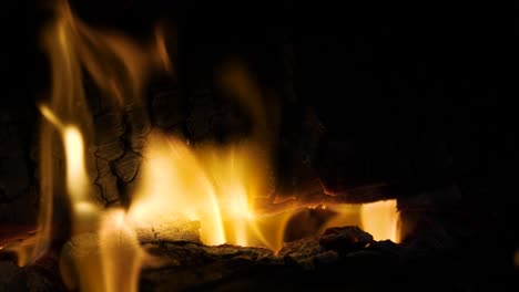 Fireplace-real-natural-wood-burning-in-fireplace,-up-close-cozy-warm-flames