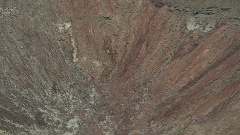 Drone-aerial-view-above-the-slope-of-the-crater-of-Volcanes-de-Bayuyo-in-Fuerteventura,-Canarias,-Spain