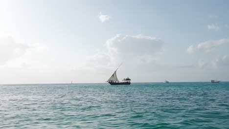 Dhow-boat-sails-in-the-ocean-at-sunny-day,-summer-concept,-Zanzibar,-Tanzania