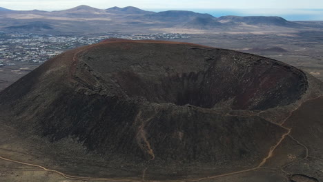 Panning-left-aerial-view-of-the-Volcano-Calderon-Hondo-in-Fuerteventura-Spain