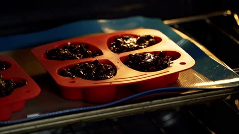 Closing-oven-baking-chocolate-chip-beet-muffins-in-red-heart-shaped-silicone-muffin-pan-valentine's-day