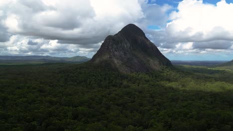 Left-to-right-aerial-view-of-the-North-face-of-Mt-Beerwah,-the-tallest-of-the-Glasshouse-Mountains-on-the-Sunshine-Coast,-Queensland,-Australia