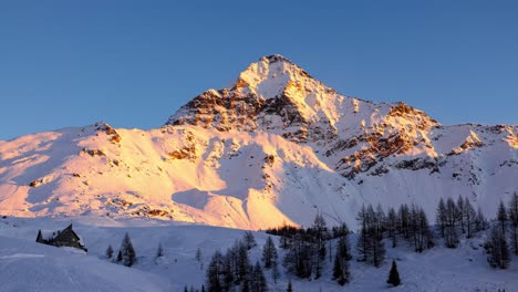 Sunset-shadows-moving-across-snowy-Pizzo-Scalino-alpine-mountain-time-lapse