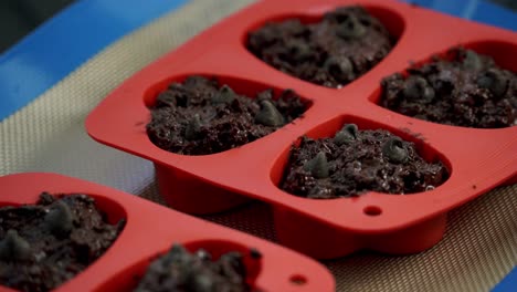 Close-up-of-chocolate-beets-muffins-inside-of-baking-tray-for-valentines-day-candy-heart-love