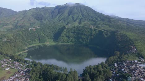 Aerial-view-of-a-crater-shaped-lake-on-a-mountain-slope,-Menjer-lake,-Indonesia