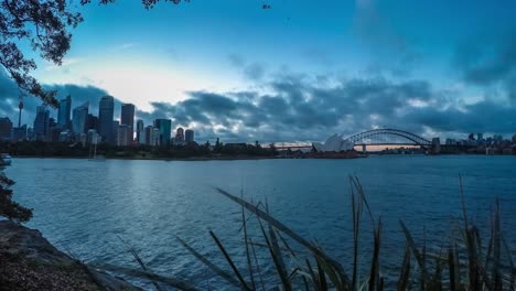 timelapse-with-wide-angle-of-sydney-skyline-and-opera-house-and-harbour-bridge-at-sunset-on-a-cloudy-day-with-beautiful-colors-taken-from-Mrs-Macquarie's-chair