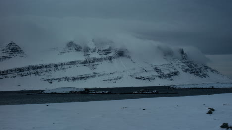Frozen-mountains-with-water-beneath-shot-from-the-car-with-a-gimbal
