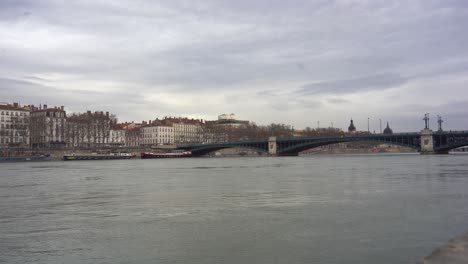 Rhone-River-Flowing-Through-Lyon's-Classic-Buildings,-Connected-by-Iron-Bridges,-Offering-a-Beautiful-Panoramic-View-of-France