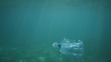 Plastic-bag-floating-underwater-with-light-reflections