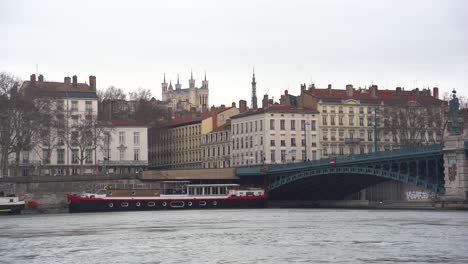 Anchored-Ships-Along-the-Banks-of-the-Rhone-River-in-Lyon,-Near-the-Old-Iron-Bridge:-Tranquil-Waterside-Scene