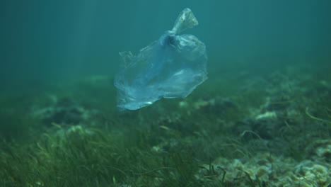 Plastic-bag-floating-underwater-with-light-reflections