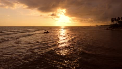 Slow-flight-over-beautiful-Caribbean-sea-along-shoreline-during-golden-sunset-at-horizon