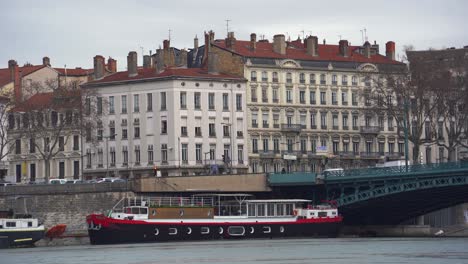 Lyon's-Charms:-Classic-Architecture,-Iron-Bridge,-and-Cruise-Ship-Along-the-Rhone-River,-Inviting-a-Scenic-Tour-Through-the-City's-Waterways