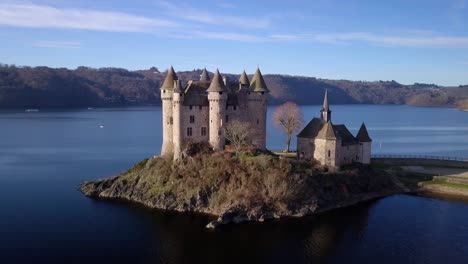 drone-shot-around-Chateau-de-Val,-beautiful-french-castle-in-Cantal-departement,-auvergne-rhone-alpes-region,-french-countryside