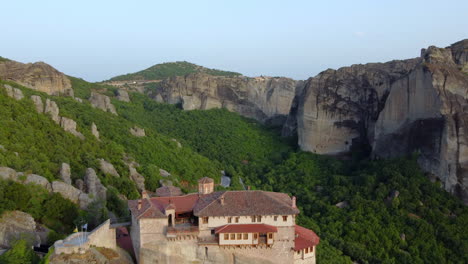 Drone-shot-of-majestic-Meteora-monasteries-and-beautiful-mountain-during-sunset