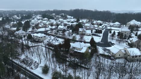 American-Neighborhood-with-snowy-roofs-at-winter-day-in-Pennsylvania,-USA---Establishing-drone-shot