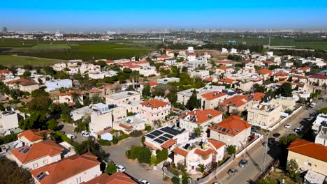 A-beautiful-town-with-red-roofs-near-Tel-Aviv,-central-Israel,-surrounded-by-green-farmers'-fields