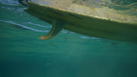 Surfer,-Der-In-Kristallklarem-Wasser-In-Byron-Bay,-Australien,-Auf-Welle-Paddelt,-Aufgenommen-Aus-Dem-Wasser-In-Zeitlupe