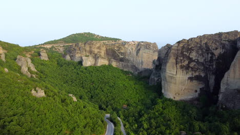 Aerial-view-of-lush-trees-growing-on-landscape-and-Meteora-monastery