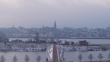 Drone-shot-moving-towards-the-Steven-church-in-the-city-of-Nijmegen-while-a-ship-crosses-the-Waal