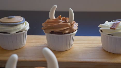 Dolly-out-flyover-Cupcakes-display-on-table-with-Viking-theme-decoration,-Slow-motion