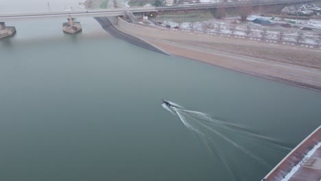 Speedboat-ripping-over-the-water,-topdown-follow-drone-shot