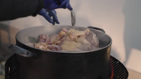 Stirring-Seasoned-Chicken-in-a-Steamy-Pot