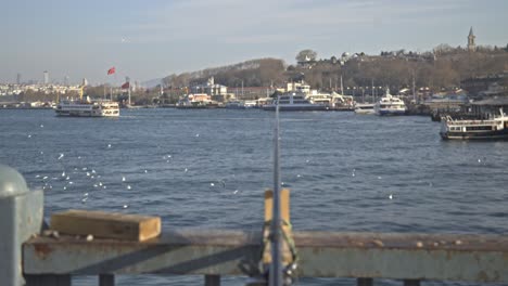 Fishermen-fishing-on-the-Bosphorus,-Galata-Bridge,-with-a-sea-view