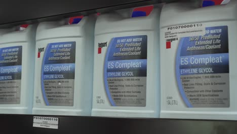 Store-shelf-with-containers-of-Fleetguard-brand-ethylene-glycol-compound-vehicle-antifreeze
