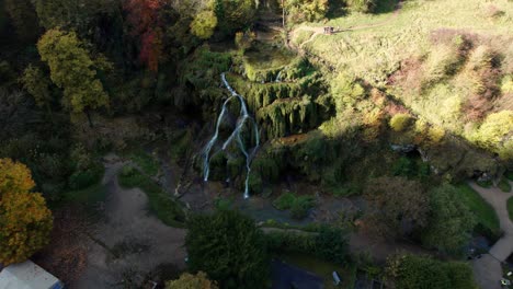 drone-shot-around-cascade-des-tufs,-beautiful-waterfall-in-Jura-near-baume-les-messieurs-town-during-autumn,-Jura-departement,-Bourgogne-Franche-Comte-region,-french-countryside