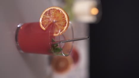 Red-cocktail-in-a-glass-rotating-on-a-circular-plate