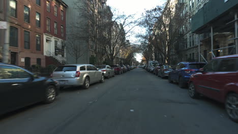POV-shot-driving-through-a-residential-neighborhood,-sunny,-fall-day-in-New-York