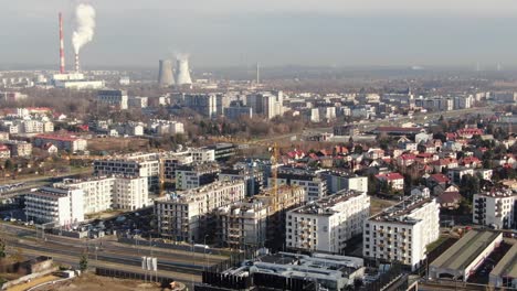 Thermal-power-plant-and-modern-apartment-blocks-in-Plaszow-district,-Krakow,-Poland-aerial-view