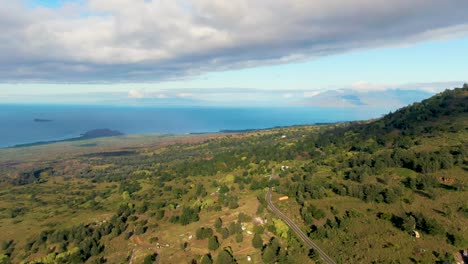 Winding-road,-green-landscape-and-Pacific-ocean-of-Hawaii-island,-aerial-view