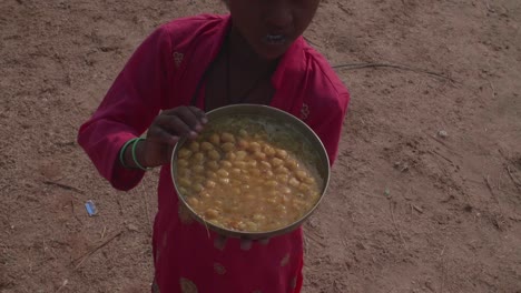 Young-Indian-child-thankful-to-have-food-shows-off-her-meal-with-pride