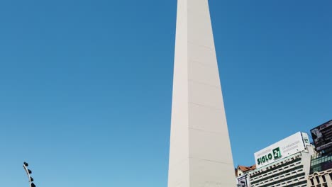 Close-up-Shot-of-Buenos-Aires-Obelisk,-City-Center-Landmark-with-Skyline-Streets