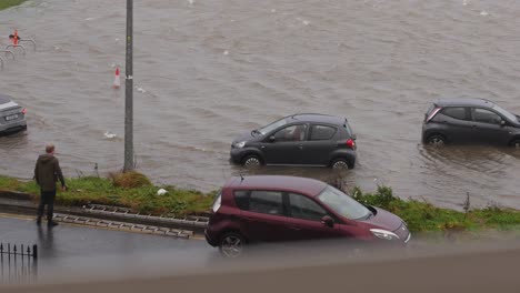 Small-car-reversing-trying-to-get-out-of-flooded-carpark