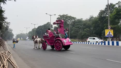 Profile-view-of-a-Pink-horse-chariot-on-Red-Road-in-Kolkata-during-daytime