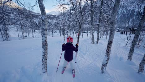 Girl-skiing-in-birch-forest-Myrkdalen-resort-Norway,-Handheld-slow-motion-follow