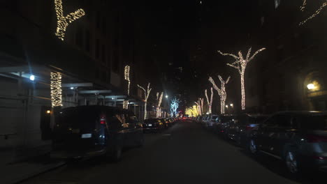 POV-shot-driving-in-middle-of-christmas-lights,-nighttime-in-Manhattan,-New-York