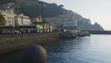 Tourists-Looking-Over-Ship-Harbor-At-Sunrise-|-Amalfi-Coast-Italy-Travel-Tourism-Sunrise-Cliffside-Coastline,-Europe,-Walking,-Shaky-4K