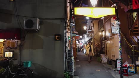 Slow-panning-establishing-shot-of-alleyway-drinking-establishing-in-popular-nightlife-area-of-tokyo